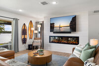 Sit by the cozy fire and grab your family for a movie night in this upgraded living space