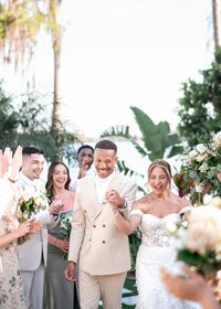 Wedding party posing outdoors among greenery at an Orlando wedding