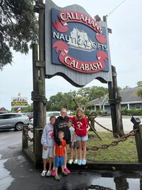 Emily, the photographer of Studio Roscher, smiling with her kids at a restaurant