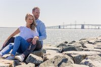 A glossy photograph taken by Studio Roscher of a happy engaged couple seaside in Richmond, VA