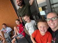 Emily, the photographer of Studio Roscher, smiling with her husband and kids