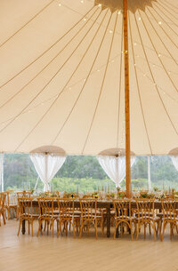 A reception tent setting with light dangling at the Wauwinet on Nantucket