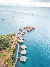 Aerial view of a luxury Mediterranean resort surrounded by turquoise blue water