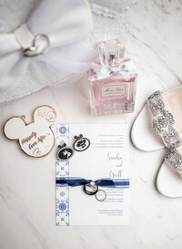 Disney wedding details flatlay with Mickey ear invitation and jewelry in Orlando