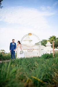 Bride and groom on the lawn near Disney's Wedding Pavilion in Orlando