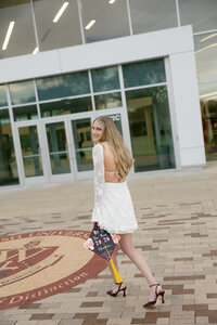 graduate walking in front of ohio school during senior photos