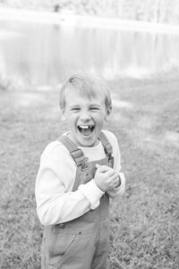 A glossy photograph taken by Studio Roscher of a happy boy outside in a park in Richmond, VA