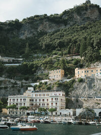 Boats and waterfront hotels beneath the cliffs of the Amalfi Coast, Italy