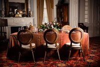 Elegant micro wedding at Rippavilla Plantation with a table set with a dark orange velvet table cloth and a large autumnal centerpiece