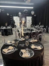black and silver balloon decor and table setting for birthday party
