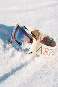 Powder - Luxury ski goggles nestled in fresh powder snow - TVS