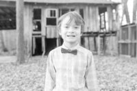 A glossy photograph taken by Studio Roscher of a smiling kid outside in a park in Richmond, VA