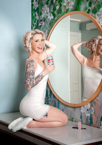 Bride getting ready and looking in the mirror before her Orlando wedding