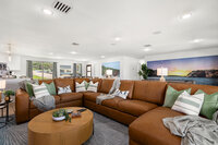 Cozy and modern lux sofa in the living room with fluffy pillows and views to the entire open floor plan main space