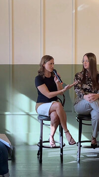 Ashley-Anne Schmidt speaking on stage at a business conference
