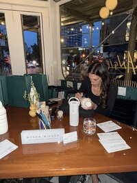 Guests experiencing live calligraphy by Use Your Words by Nyssa with personalized keepsakes created during a New Jersey wedding event.