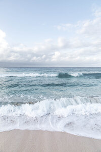 Turquoise ocean waves breaking along a scenic Mediterranean coastline