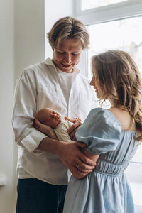 couple admiring newborn baby