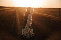 Woman wearing angel wings during an editorial boudoir session near Wichita, Kansas.