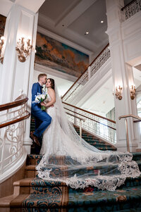 Bride and groom on a grand staircase at a luxury Orlando wedding venue