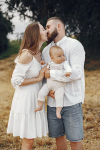 kissing couple with baby