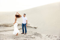 Couple posed together on the sand dunes during a Palm Springs photography session