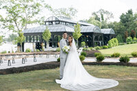 bride and groom standing and smiling in front of their ohio wedding venue