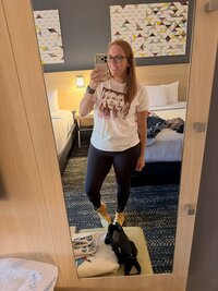 Emily, the photographer of Studio Roscher, smiling in a hotel room for a Hilary Duff concert