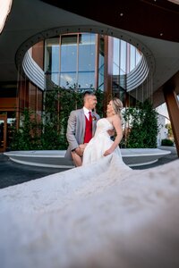Bride and groom in a glass atrium at a modern Orlando wedding venue