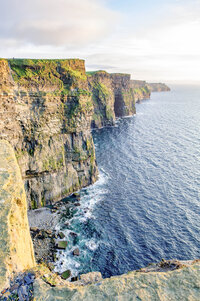 Dramatic Irish cliffs rising above the blue Mediterranean Sea