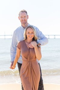 A glossy photograph taken by Studio Roscher of a happy engaged couple seaside in Richmond, VA