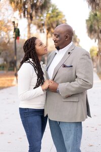 A glossy photograph taken by Studio Roscher of a happy married couple outside in a park in Savannah, GA