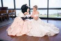 Bride in a blush ballgown sharing a moment before her Orlando wedding