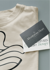 Adventurous Heart Therapy business card featuring custom typography and wave-inspired brand elements