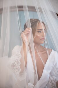 Bride peeking through her veil at an Orlando wedding