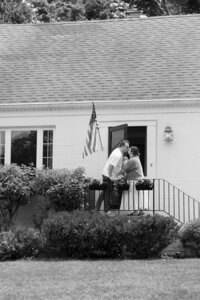 couple kissing in front of their home in ohio