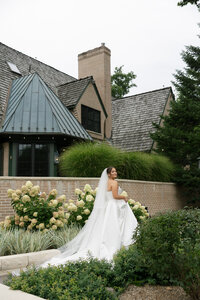 bride walking across the front of her wedding venue