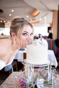 Bride playfully tasting the wedding cake at an Orlando reception