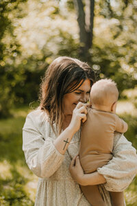 Mother holding her baby outside