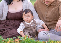 family-sitting-on-grass-autumn-portrait-melbourne