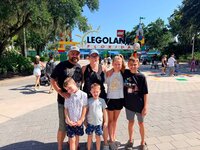 Emily, the photographer of Studio Roscher, smiling with her husband and kids at Legoland