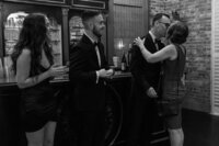 A black and white photo of family members greeting their mother at a birthday party in Richmond, VA