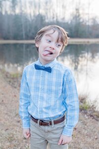 A glossy photograph taken by Studio Roscher of a silly kid outside in a park in Richmond, VA