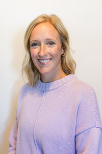 A classic professional portrait taken by Studio Roscher of a female professional smiling in a studio
