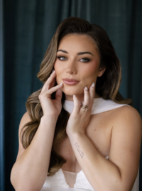 Close-up bridal portrait showcasing natural wedding makeup, flowing brunette hair, and elegant bridal styling before the ceremony.