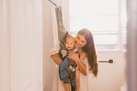 Mother wrapping her baby in a towel during a family photo session in Houston Texas