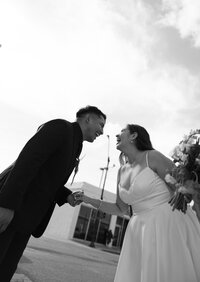 Bride and groom laughing together after their wedding ceremony during a candid black-and-white portrait captured by a San Antonio wedding photographer.