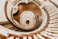 Bridal portrait down spiral staircase at Nashville Tennessee venue — Weddings & Events by Raina