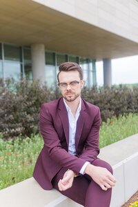 A classic professional portrait taken by Studio Roscher of a male professional smiling in a park