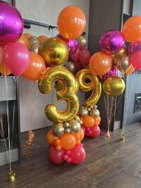 gold number balloons with pink and orange balloons